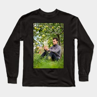 Teenager reading a book in the orchard Long Sleeve T-Shirt